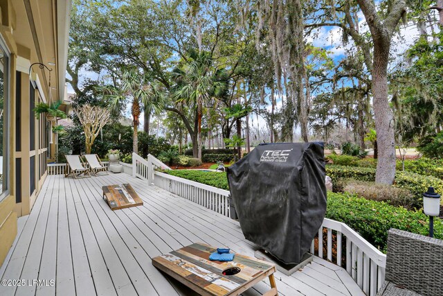 wooden terrace featuring a grill and outdoor dining area