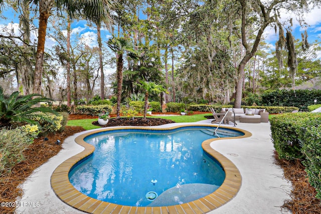 outdoor pool featuring a patio area and an outdoor hangout area