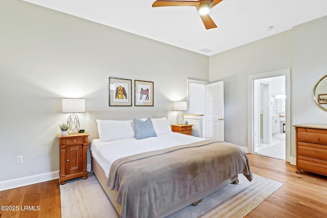 bedroom featuring ensuite bathroom, ceiling fan, light wood-type flooring, and baseboards