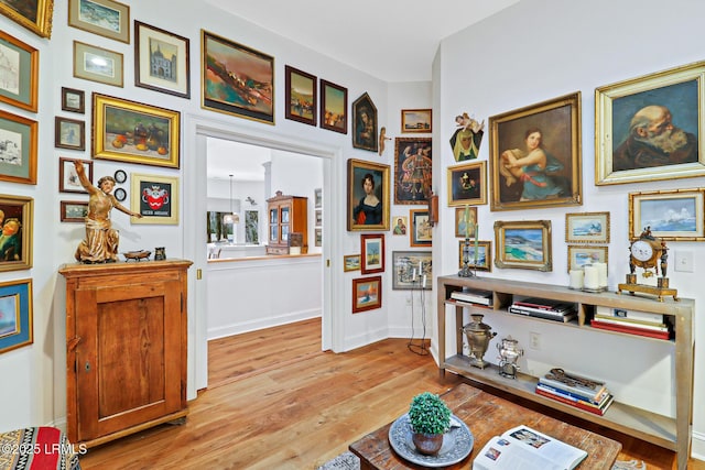 living area with light wood finished floors and baseboards