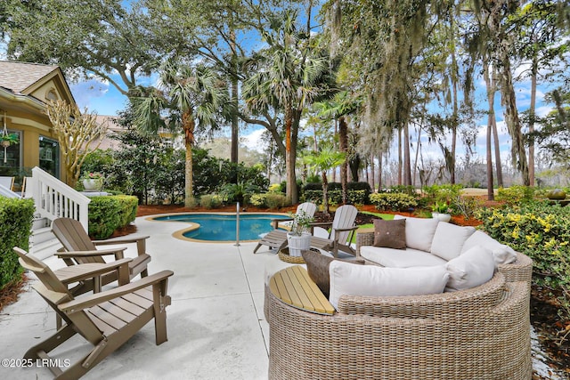 pool with an outdoor hangout area and a patio area