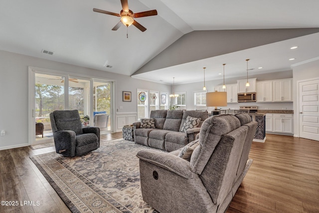 living area with a ceiling fan, wood finished floors, visible vents, and high vaulted ceiling