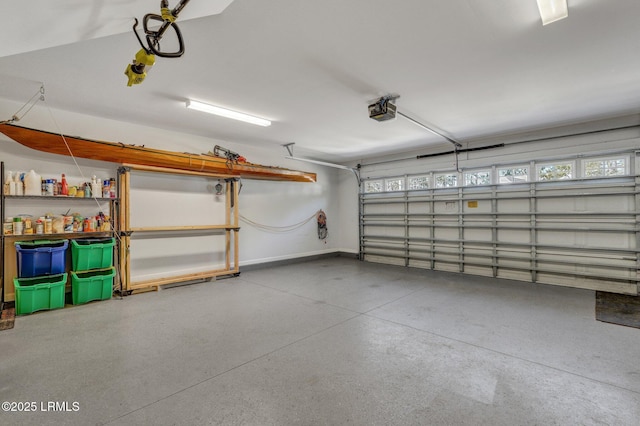 garage with baseboards and a garage door opener