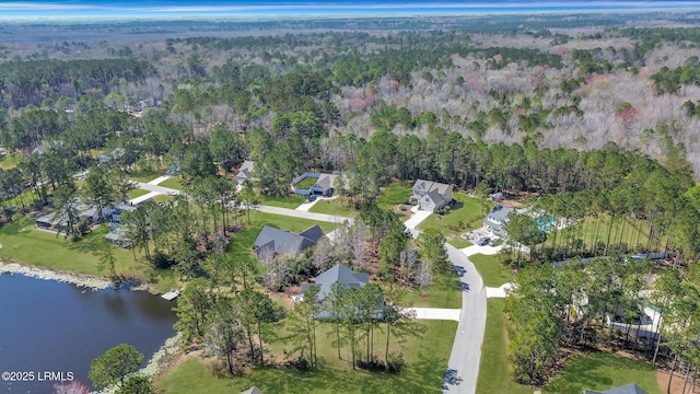 aerial view featuring a view of trees and a water view