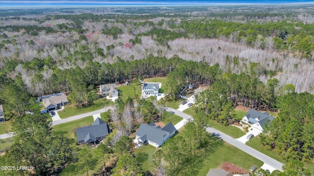 bird's eye view featuring a forest view and a residential view