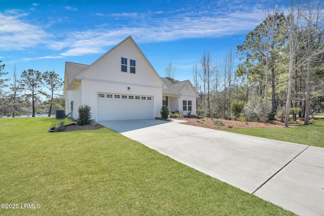 modern inspired farmhouse with a garage, driveway, and a front lawn