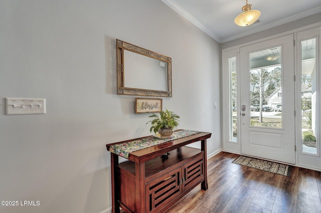 foyer featuring hardwood / wood-style flooring, baseboards, and ornamental molding