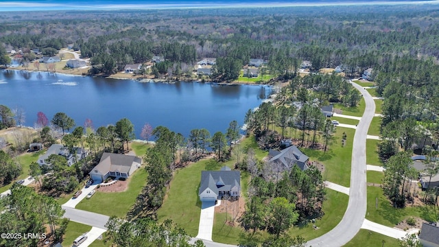 aerial view with a wooded view, a water view, and a residential view