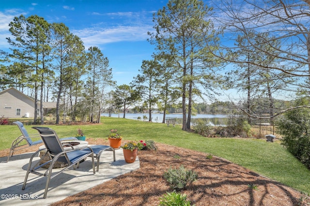 view of yard with a patio and a water view