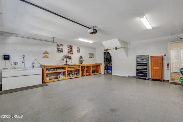 garage featuring a workshop area and a garage door opener