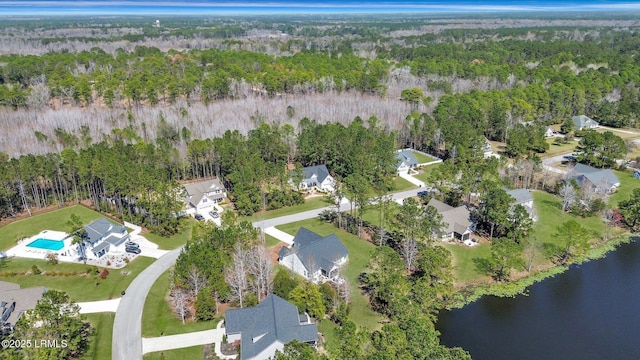 aerial view with a wooded view and a water view