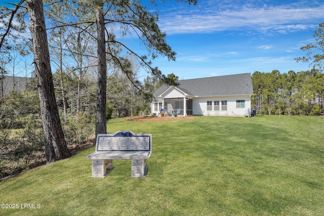 view of front facade featuring a front lawn and a sunroom