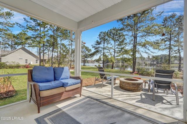 sunroom / solarium with a water view