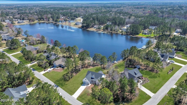 drone / aerial view featuring a residential view and a water view