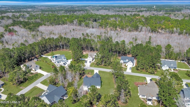 birds eye view of property with a wooded view and a residential view