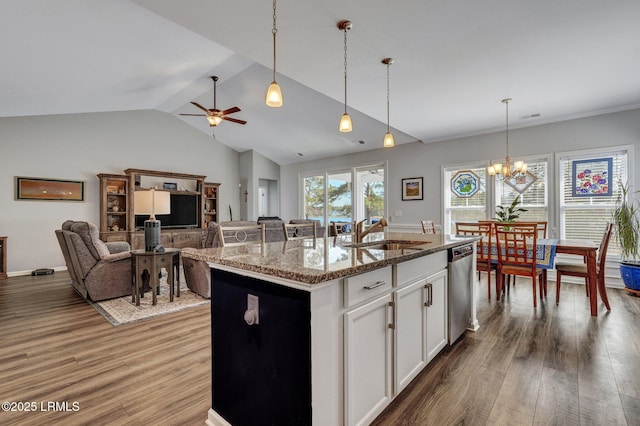 kitchen with stainless steel dishwasher, an island with sink, wood finished floors, and a sink