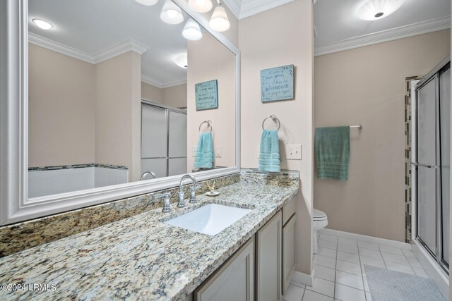 bathroom featuring toilet, crown molding, vanity, a shower with door, and tile patterned flooring