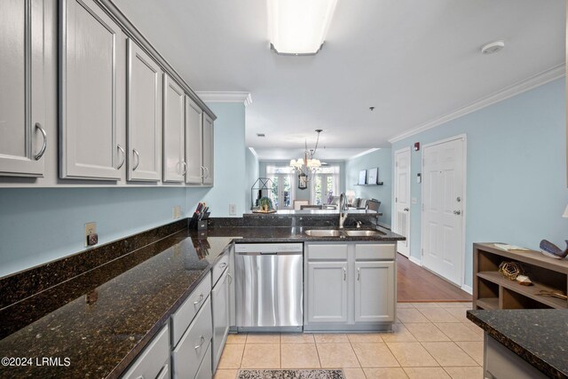 kitchen with sink, light tile patterned floors, hanging light fixtures, stainless steel dishwasher, and kitchen peninsula