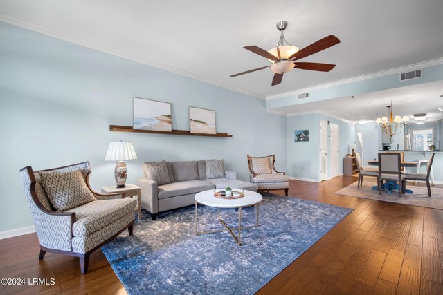 living room featuring crown molding, dark hardwood / wood-style flooring, and ceiling fan with notable chandelier