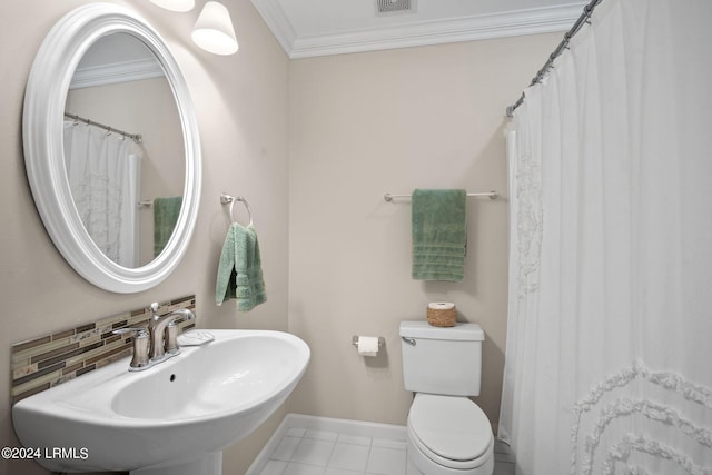 bathroom featuring tasteful backsplash, crown molding, sink, and toilet