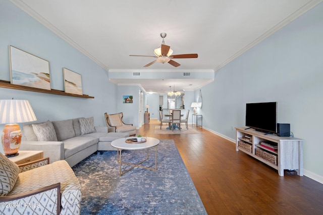 living room with ornamental molding, dark hardwood / wood-style floors, and ceiling fan with notable chandelier