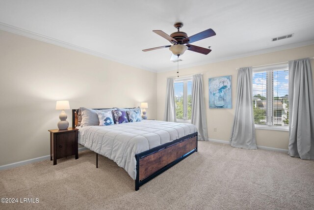 bedroom featuring light carpet, multiple windows, and ceiling fan