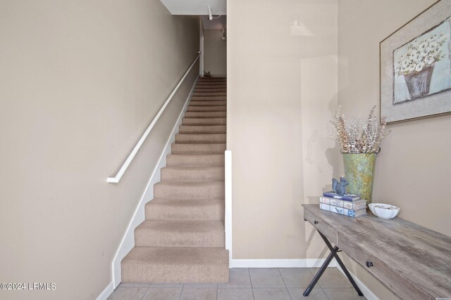 stairs with tile patterned floors