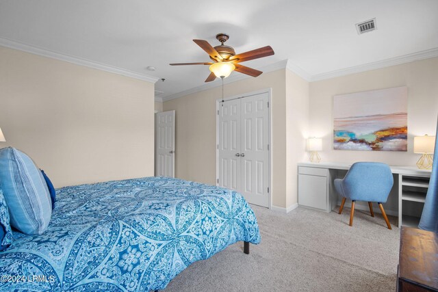 carpeted bedroom featuring crown molding, a closet, and ceiling fan