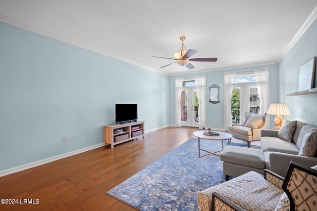 living room with crown molding, wood-type flooring, french doors, and ceiling fan