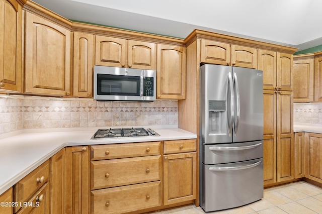 2 Doe Pt, Dataw Island, SC 29920 - kitchen with stainless steel appliances, tasteful backsplash, light countertops, and light tile patterned floors