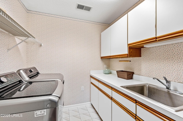 2 Doe Pt, Dataw Island, SC 29920 - laundry room with separate washer and dryer, cabinet space, light tile patterned floors, and wallpapered walls