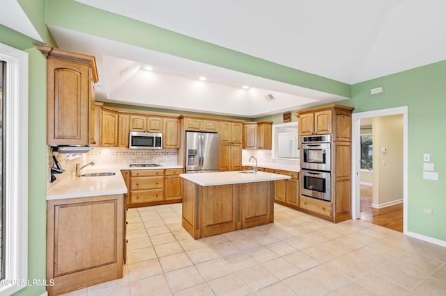 2 Doe Pt, Dataw Island, SC 29920 - kitchen featuring stainless steel appliances, a center island with sink, backsplash, light countertops, and light tile patterned floors