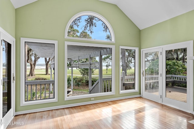 2 Doe Pt, Dataw Island, SC 29920 - unfurnished sunroom with high vaulted ceiling and wood-type flooring