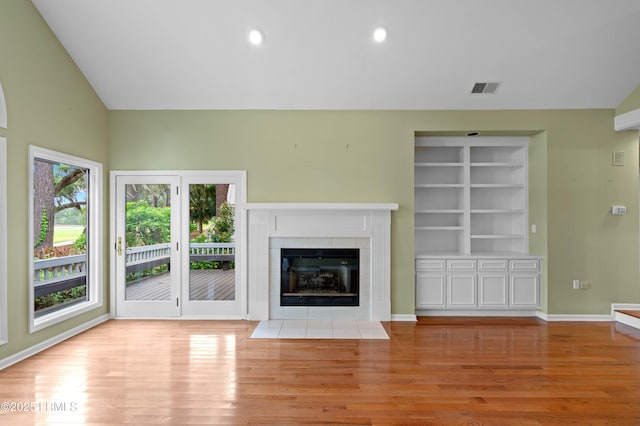 2 Doe Pt, Dataw Island, SC 29920 - unfurnished living room featuring light wood finished floors, a tiled fireplace, lofted ceiling, and recessed lighting