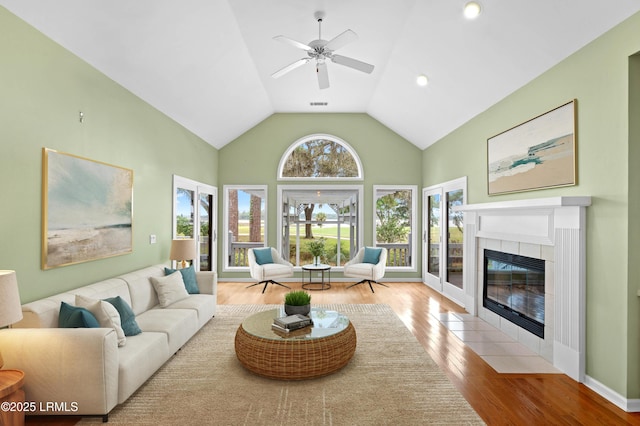 2 Doe Pt, Dataw Island, SC 29920 - living area with wood finished floors, ceiling fan, a tile fireplace, and high vaulted ceiling