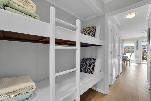 bedroom featuring crown molding and wood-type flooring