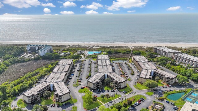 aerial view with a water view and a beach view