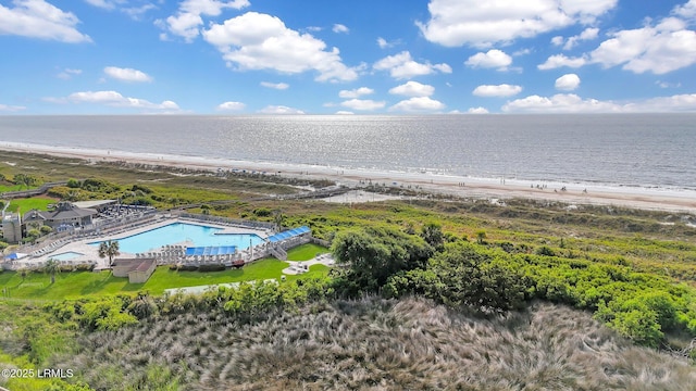 drone / aerial view with a water view and a beach view