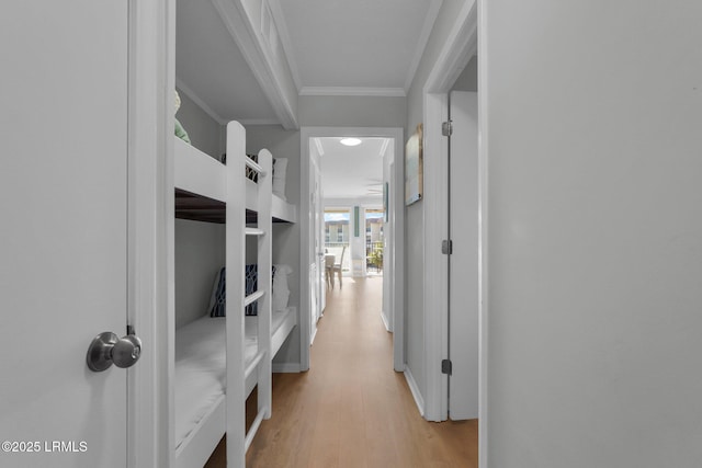 hall featuring crown molding and light hardwood / wood-style floors