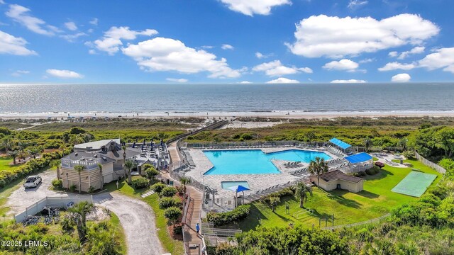 birds eye view of property featuring a water view and a beach view