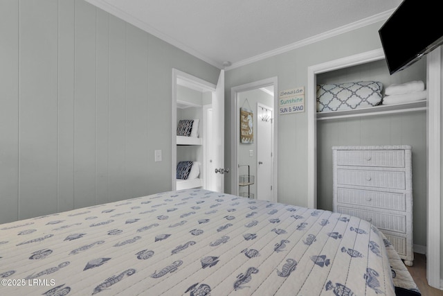 bedroom featuring ornamental molding, wooden walls, and a closet