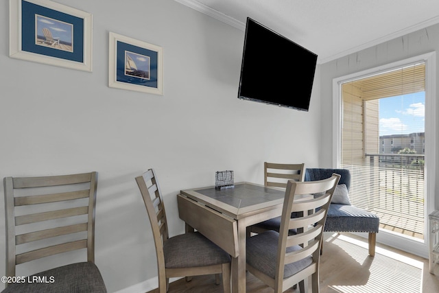 dining room with crown molding and a wealth of natural light