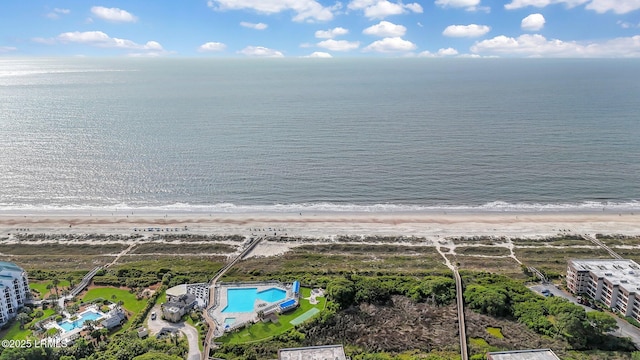 drone / aerial view featuring a water view and a view of the beach