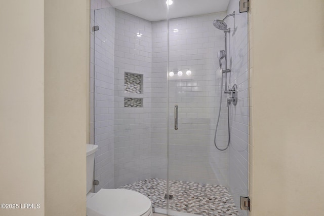 bathroom with walk in shower and toilet