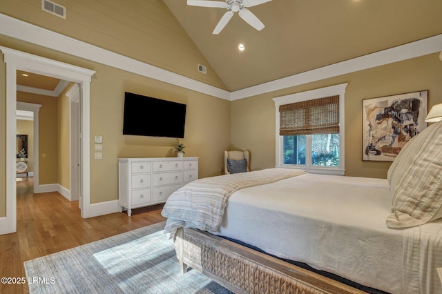 bedroom featuring ceiling fan, high vaulted ceiling, and light wood-type flooring