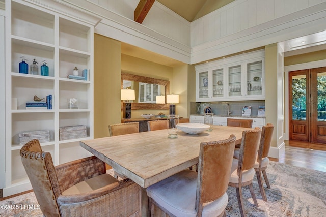 dining space featuring built in shelves and light hardwood / wood-style flooring