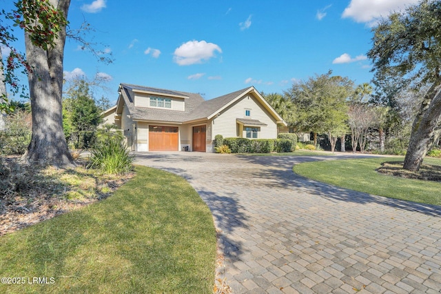 front of property with a garage and a front yard