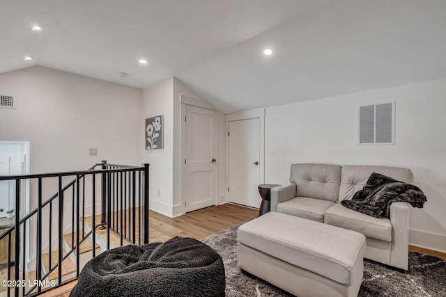 living room with lofted ceiling and hardwood / wood-style floors