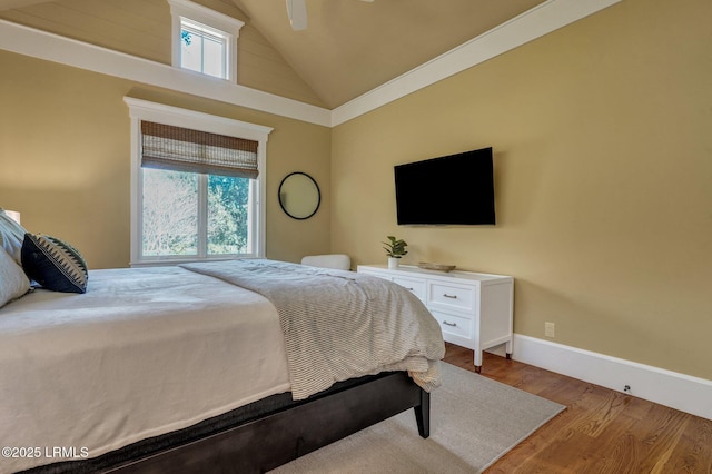 bedroom featuring hardwood / wood-style flooring, ceiling fan, and high vaulted ceiling