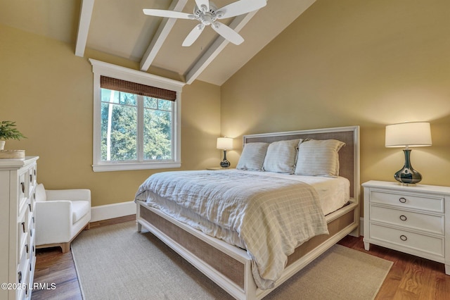 bedroom featuring hardwood / wood-style flooring, ceiling fan, and vaulted ceiling with beams